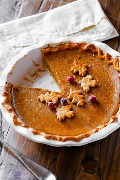 a slice of pumpkin pie with cranberries on top