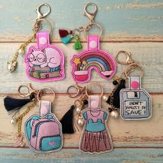 several key chains with different designs on them