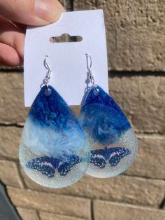 Resin Dangle Earrings silver plated/butterfly/Clouds/Glitter/Great Gift idea/Birthday Dimensions: Cloud Butterfly- L: HxW 6.3 Cm x 4.3cm/2.4in X 1.6 in Butterfly- M: HxW 5cm x 3.6cm/1.9in X 1.4in Pink- S:HxW 3.7cm x 2.6 Cm/1.4in X 1.0in Purple/Blue #1- S:HxW 3.7cm x 2.6 Cm/1.4in X 1.0in Purple/Blue #2- M: HxW 5cm x 3.6cm/1.9in X 1.4in Purple/Blue #3- L: HxW 6.3 Cm x 4.3cm/2.4in X 1.6 in Cloud - M: HxW 5cm x 3.6cm/1.9in X 1.4in Butterfly Charm Drop Earrings As Gift, Butterfly Charm Drop Earrings For Gift, Butterfly Party Earrings With Ear Wire, Hypoallergenic Butterfly Jewelry For Parties, Butterfly Charm Earrings For Party, Dangle Earrings With Butterfly Charm As Gift, Blue Butterfly Charm Dangle Earrings, Blue Dangle Earrings With Butterfly Charm, Blue Butterfly Charm Earrings For Gift