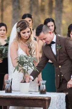 a bride and groom are getting ready to cut the cake at their outdoor wedding ceremony