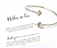 a mother in law bracelet with pearls and crystals on it next to a thank card