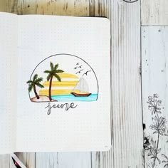 a notebook with an image of a sailboat and palm trees