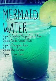 a jar filled with green liquid next to a swimming pool and the words mermaid water on it