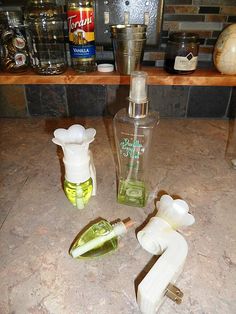 the kitchen counter is cluttered with bottles and other household cleaning products, including soap dispensers