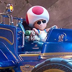 an animated character is driving a toy car