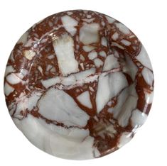 a marble plate with white and brown designs on it