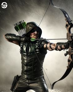 a man dressed in black holding a bow and arrow