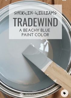 there is a paint can with a brush in it and the words tradewind above it