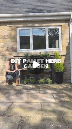 a woman sitting on a bench in front of a house with the words diy pallet herb garden