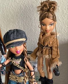 two dolls are standing next to each other