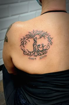 a woman with a tree tattoo on her back