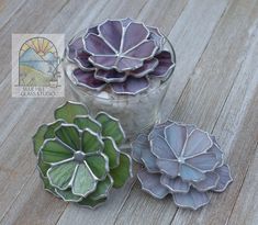 three flower shaped dishes sitting on top of a wooden table