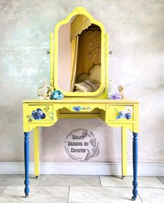 a yellow table with a mirror on top of it