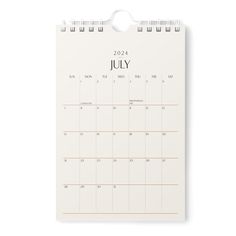 a calendar with the word july on it and a white paper clipping next to it