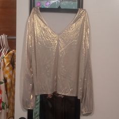 A Beautiful Long Sleeve Blouse With A Shimmery White Gold Metallic Sheen. New Without Tags, Only Tried On. Color Is Accurate In The Photos. Fabric Has No Stretch. Completely Sold Out On Shein! 24in Pit To Pit, 23in From Top Of Shoulder To Hem. Feel Free To Leave Any Questions You May Have In The Comments! Don't Like The Price? Make An Offer! Silver V-neck Top For Fall, Chic Silver V-neck Top, Chic Metallic V-neck Top, Sheen Long Sleeve Top For Night Out, Long Sleeve Sheen Top For Night Out, Glamorous Shiny Gold Tops, Metallic V-neck Top For Summer, Metallic V-neck Top For Fall, Metallic V-neck Top For Party