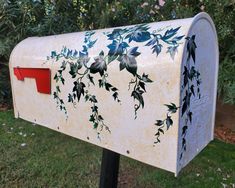 a white mailbox with blue flowers painted on it