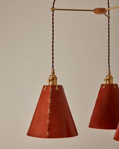 two red pendant lights hanging from a ceiling