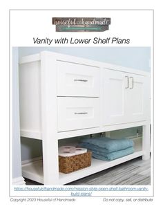 a white bathroom vanity with two drawers and towels on the bottom shelf next to it