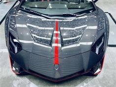 the front end of a black and red sports car