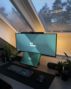 a computer monitor sitting on top of a desk next to a keyboard and mouse in front of a window