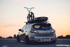 a car with a bike on the roof rack