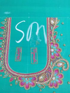 an embroidered piece with the word son written in white ink on a turquoise background,