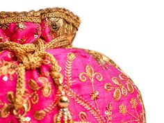 Pink Potli Bag with Pearl Handle Strap With its classy zari work and a pearl handle strap all in gold, this Pink Potli Bag is ideal for this wedding season. Fabric: Raw Silk Color: Pink Embroidery: Zari Work in Gold Size & Dimensions: Height - 8 inWidth - 7.5 inDepth - 1.5 in Strap: Pearl Handle Strap Closure: Tasseled Drawstring Compartments: Single compartment Care: Wipe with a soft, clean & dry cloth to remove dust When not in use, store it in a dust bag for longer product life Avoid Bridal Mask, Ethnic Bag, Potli Bags, Royal Blue And Gold, I Got Married, Indian Design, Raw Silk, Bridal Outfits, Indian Bridal