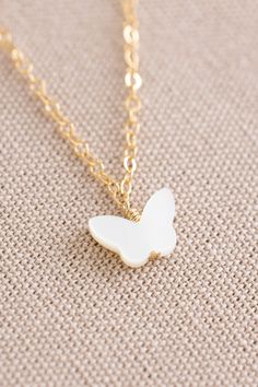 Dainty 14k gold filled small plain chain with a 7mm x 10mm mother of pearl butterfly pendant White Dainty Hypoallergenic Charm Necklace, Dainty White Hypoallergenic Charm Necklace, White Butterfly Charm Pendant Jewelry, Dainty White Butterfly Pendant Necklace, White Butterfly Charm Jewelry Gift, White 14k Gold Filled Pendant Charm Necklaces, Delicate White Butterfly Necklace For Gift, White Butterfly Necklace With Adjustable Chain For Gift, White Butterfly Necklace With Adjustable Chain As Gift