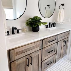 a bathroom with two round mirrors above the sinks