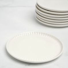 white plates stacked on top of each other