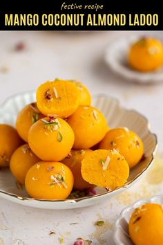 mango coconut almond ladoos in a white bowl on a table with other dishes