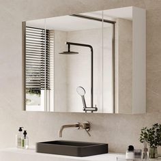 a bathroom sink sitting under a mirror next to a window