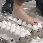 a person with their foot in an egg carton