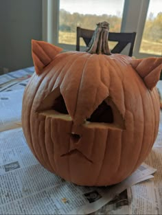 a pumpkin carved to look like a cat's face