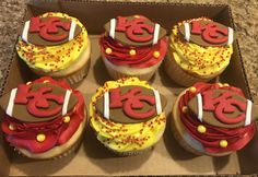 six decorated cupcakes in a cardboard box on a counter top, with the number 35 on them