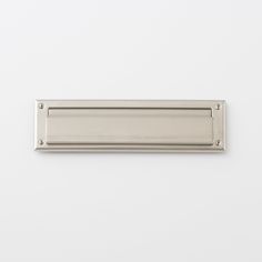 a stainless steel door handle on a white wall