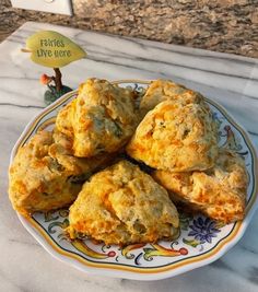 some biscuits on a plate with a sign in the background