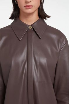 Women's Long Leather Shirt In Coffee Brown Introducing the women's long leather shirt in a rich coffee brown, meticulously crafted from genuine cowhide with a semi-aniline finish for a touch of sophistication. This shirt features a classic turn-down collar, button cuffs, and a comfortable viscose lining. Its button closure and full sleeves design blend timeless style with modern appeal, making it a versatile addition to any fashion-forward wardrobe. Outer Shell: Genuine Leather Leather Type: Cow Brown Lapel Collar Top For Work, Brown Leather Long Sleeve Top, Brown Spread Collar Tops For Work, Brown Collared Business Tops, Brown Collared Tops For Business, Brown Business Top For Fall, Brown Business Tops For Fall, Brown Tops With Concealed Placket For Fall, Elegant Brown Long Sleeve Top For Business