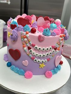 a birthday cake decorated with hearts and beads