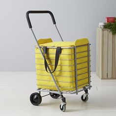 a yellow shopping cart sitting on top of a white floor