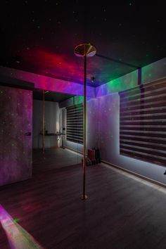 an empty room is lit up with colorful lights