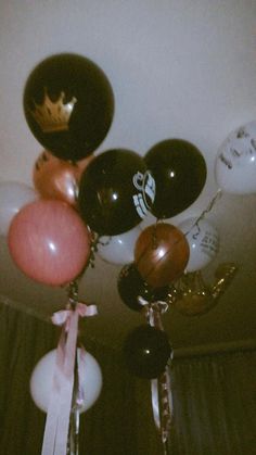 a bunch of balloons that are hanging from the ceiling