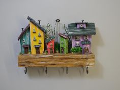 Wooden key holder with colorful houses on shelf,4 Hooks,Key organizer entryway,Cute interior decor,Decorative wall key holder,Key hang. This wooden key holder is made of pine wood. Small wooden houses made of old wood and screws, nails, bolt washers and more.The houses are hand painted with eco-friendly water-based paints.All the materials I use are Eco, they come from repairing and recycling. I give a second life to old, forgotten materials.   Wall key rack has special hangers. Designed to hang on the wall. It is perfect for your entryway and it will be a great addition in any home. * Dimensions Width: 24cm Height: 22 cm Weight: 480 g  You can see more products here: https://www.etsy.com/shop/CreativeCraftFamilyR Thank you for visiting my store Cute Interior, Wooden Miniature, Cabin Crafts, Wooden Key Holder, Colorful Houses