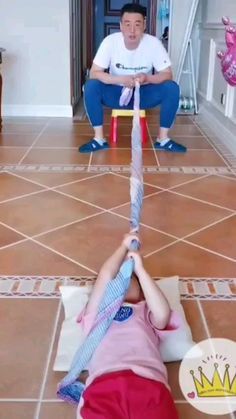 two children are playing on the floor with an upside down toy in front of them