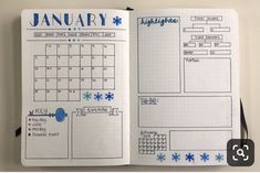 an open planner book with blue snowflakes on the pages and writing in it