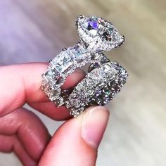 a person holding two diamond rings in their hand