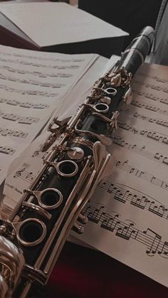 a flute sitting on top of sheet music