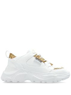 white/gold-tone leather smooth grain glitter detailing logo patch to the side logo-print tongue pull-tab at the heel round toe front lace-up fastening branded insole chunky rubber sole Versace Sneakers, Round Toe Sneakers, Detailing Logo, Versace Logo, Versace Jeans Couture, Chunky Sneakers, Summer Beach Wear, Versace Jeans, Ballet Flat Shoes