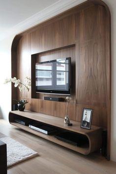 an entertainment center with a flat screen tv mounted on the wall