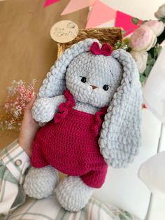 a crocheted stuffed rabbit in a red dress